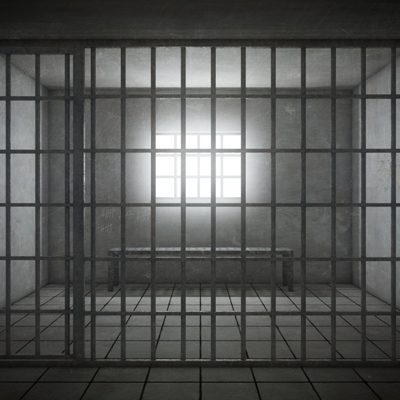 Prison cell with light shining through a barred window. 3d rendering